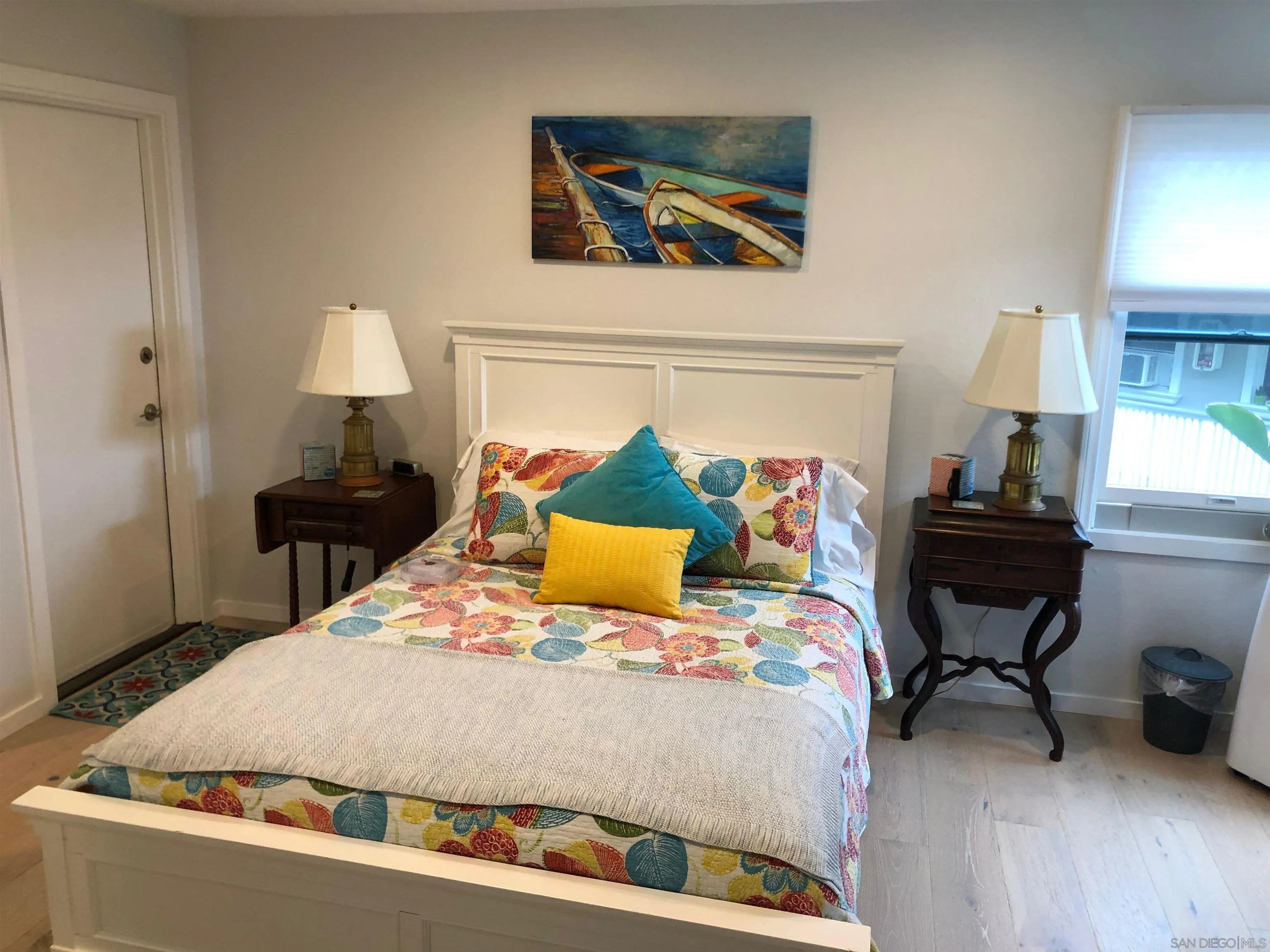 940 Sealane Drive, Unit 5 Encinitas, CA 92024 - Photo 15 of 49 a bedroom with a bed and wooden floor