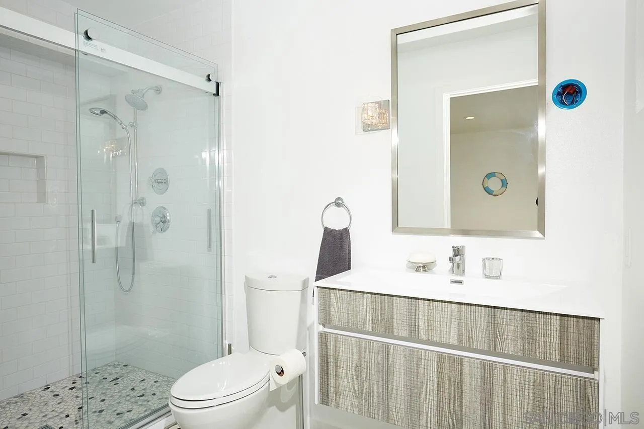 940 Sealane Drive, Unit 5 Encinitas, CA 92024 - Photo 19 of 49 a bathroom with a sink a toilet and shower