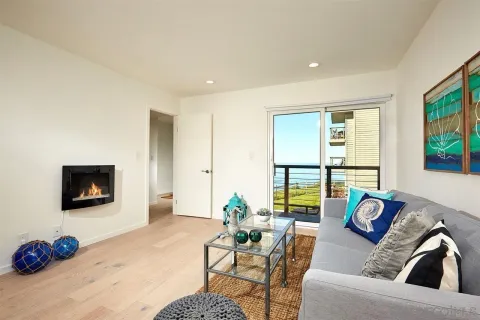 a view of a balcony with floor to ceiling windows with wooden floor