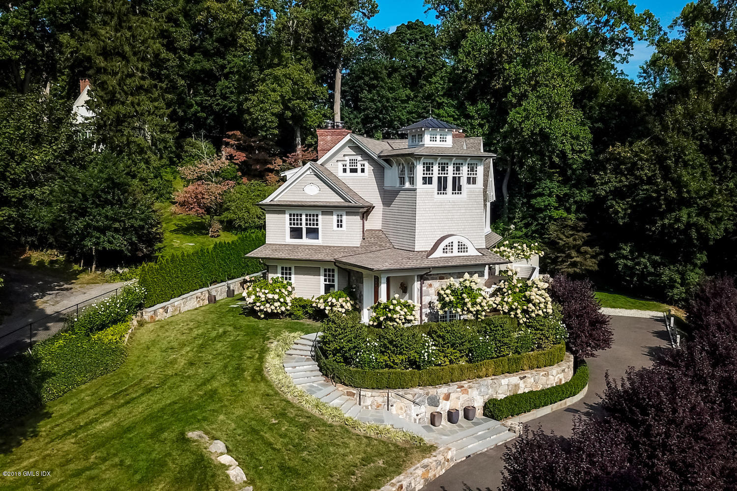 50 Hillside Drive Greenwich, CT 06830 - Photo 3 of 16 a view of a house with a yard and potted plants