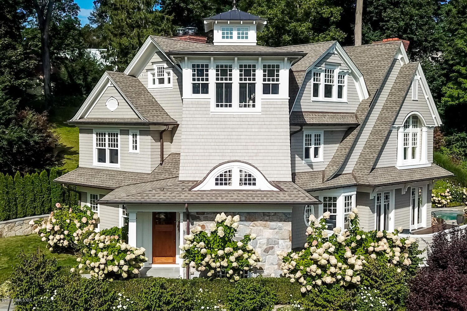 50 Hillside Drive Greenwich, CT 06830 - Photo 4 of 16 a front view of a house with a garden