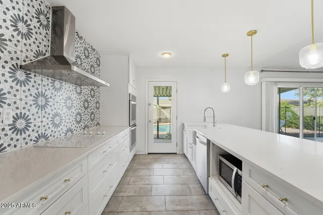 a large white kitchen with a stove and a bathtub