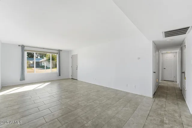 an empty room with windows and closet