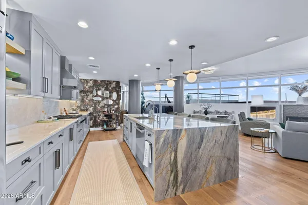 a large kitchen with stainless steel appliances lots of counter space and a sink