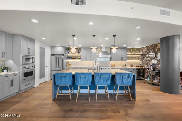 a large kitchen with stainless steel appliances lots of counter top space