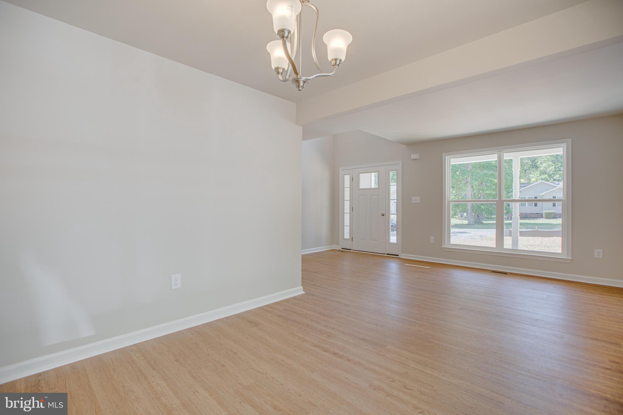 282 Circle Lane Colonial Beach, VA 22443 - Photo 12 of 57 a view of an empty room with wooden floor and a window