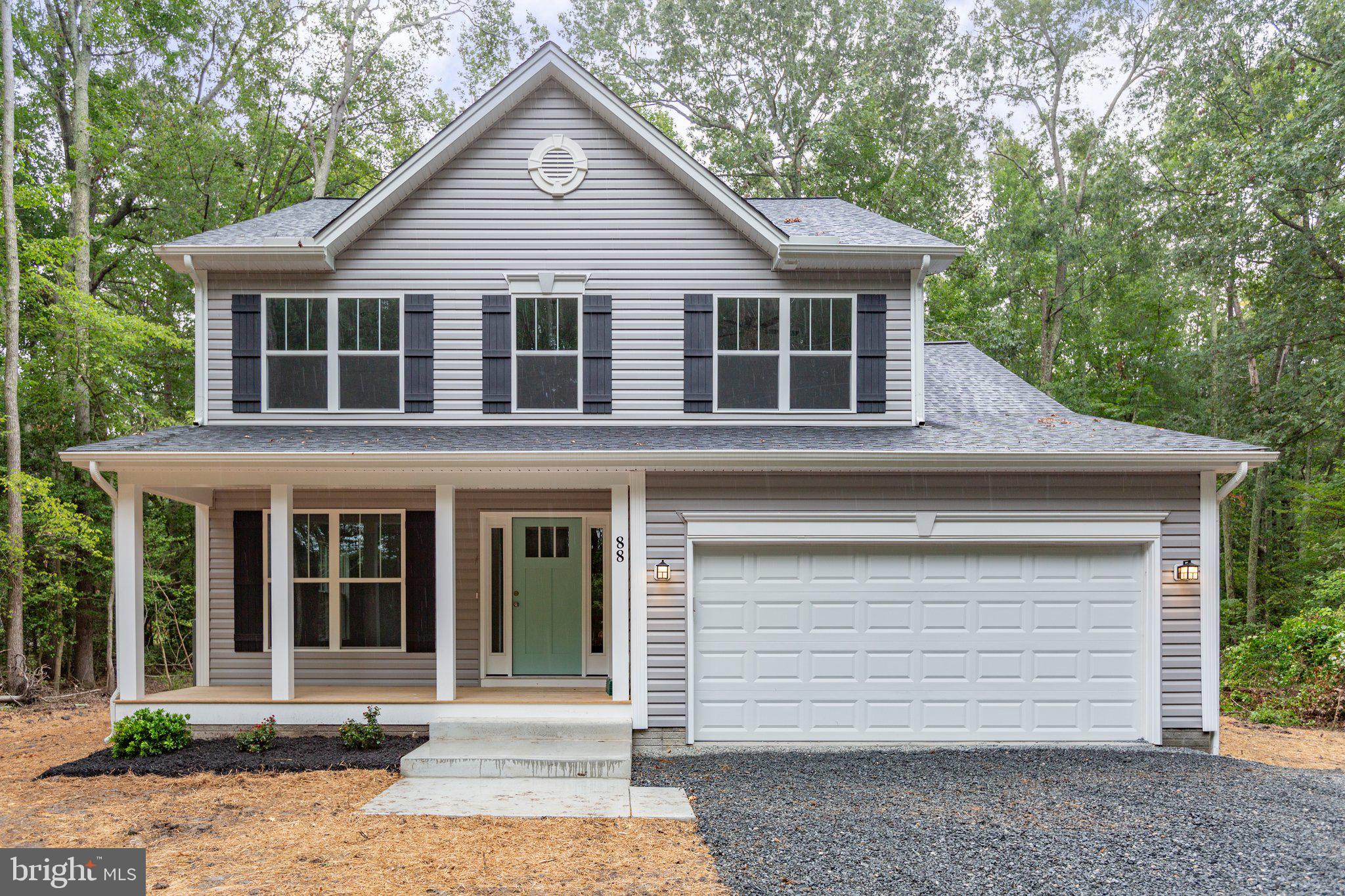 282 Circle Lane Colonial Beach, VA 22443 - Photo 36 of 57 a front view of a house with a yard and garage