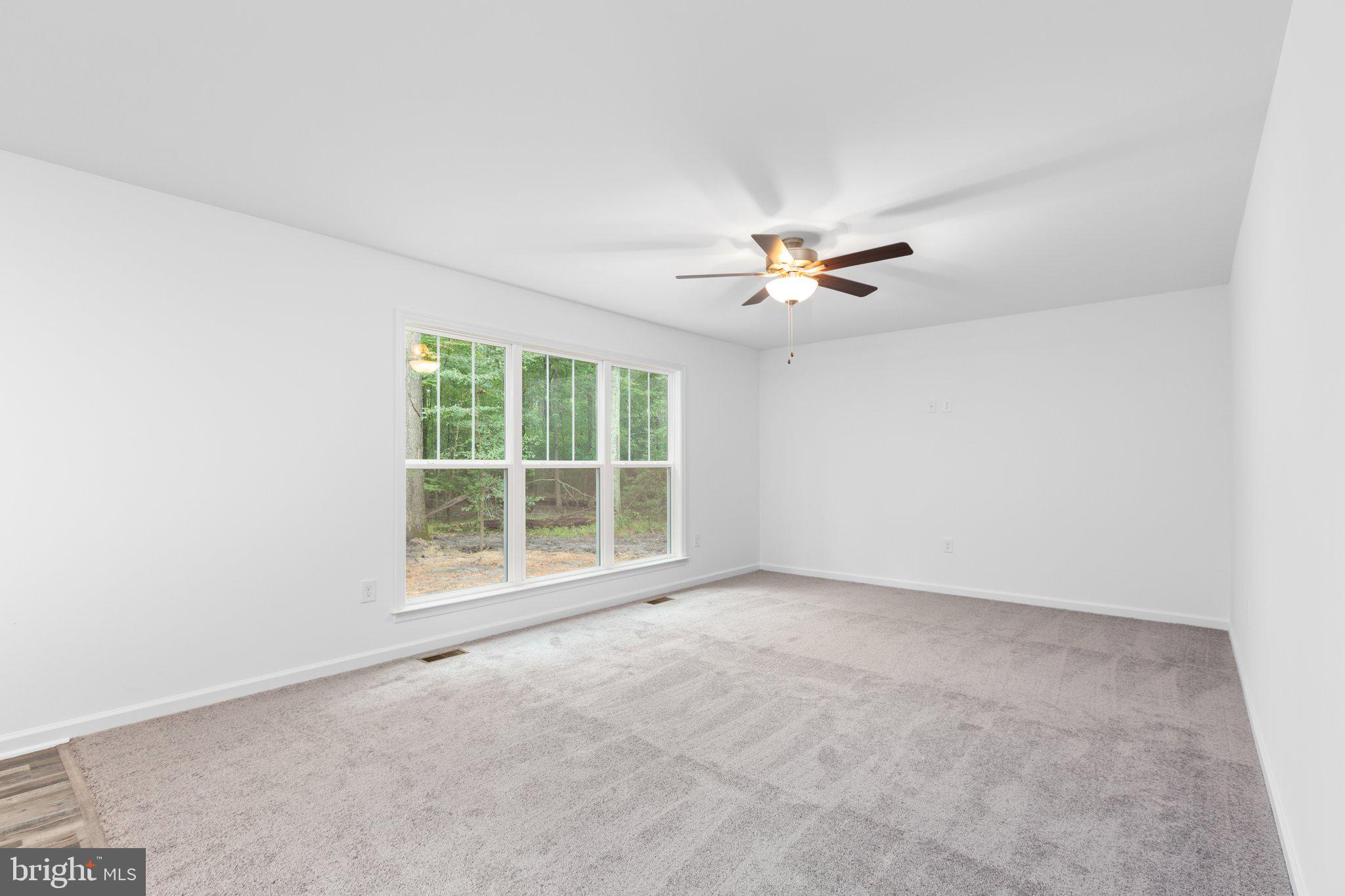 282 Circle Lane Colonial Beach, VA 22443 - Photo 43 of 57 an empty room with a ceiling fan and a window