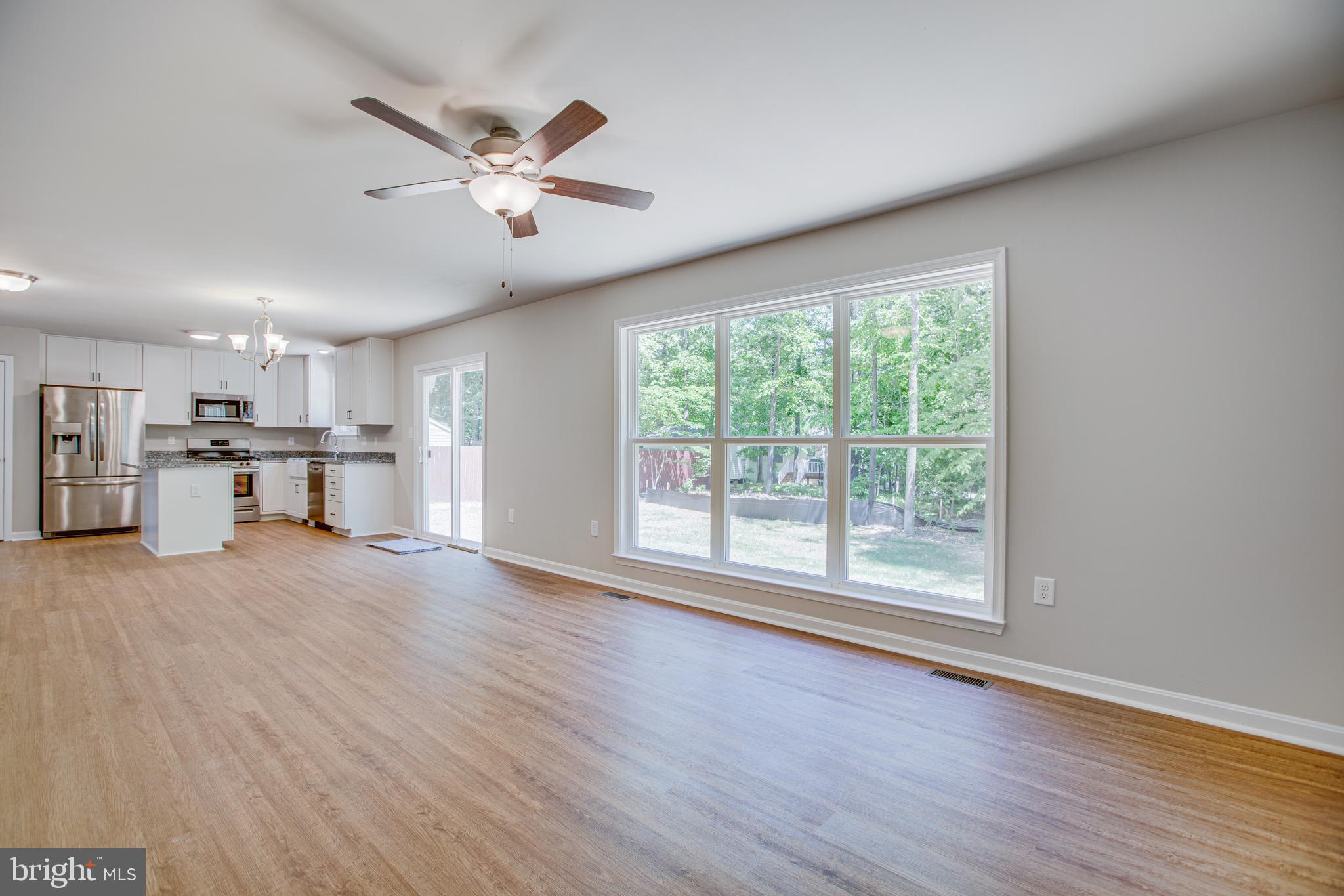 282 Circle Lane Colonial Beach, VA 22443 - Photo 8 of 57 a view of an empty room with a window and wooden floor