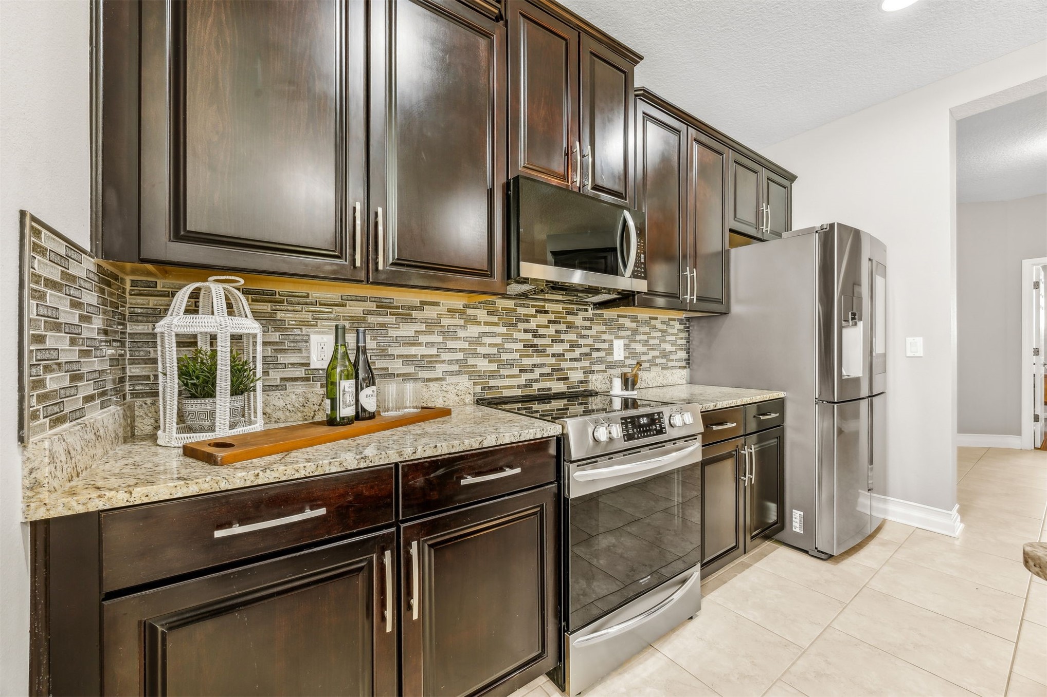95050 Poplar Way Fernandina Beach, FL 32034 - Photo 10 of 42 a kitchen with granite countertop stainless steel appliances and wooden cabinets