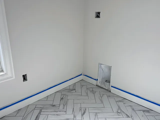 a view of staircase with railing and white walls