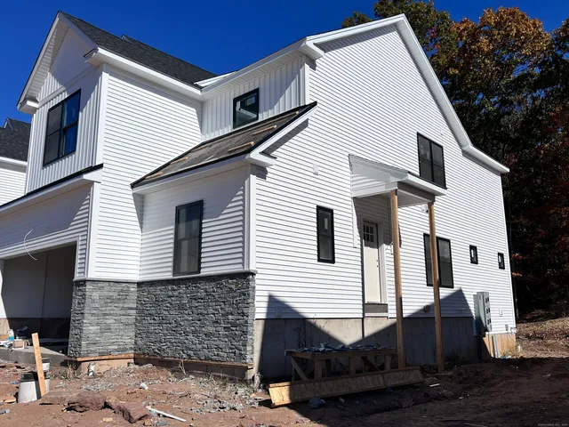 a view of a white house with many windows