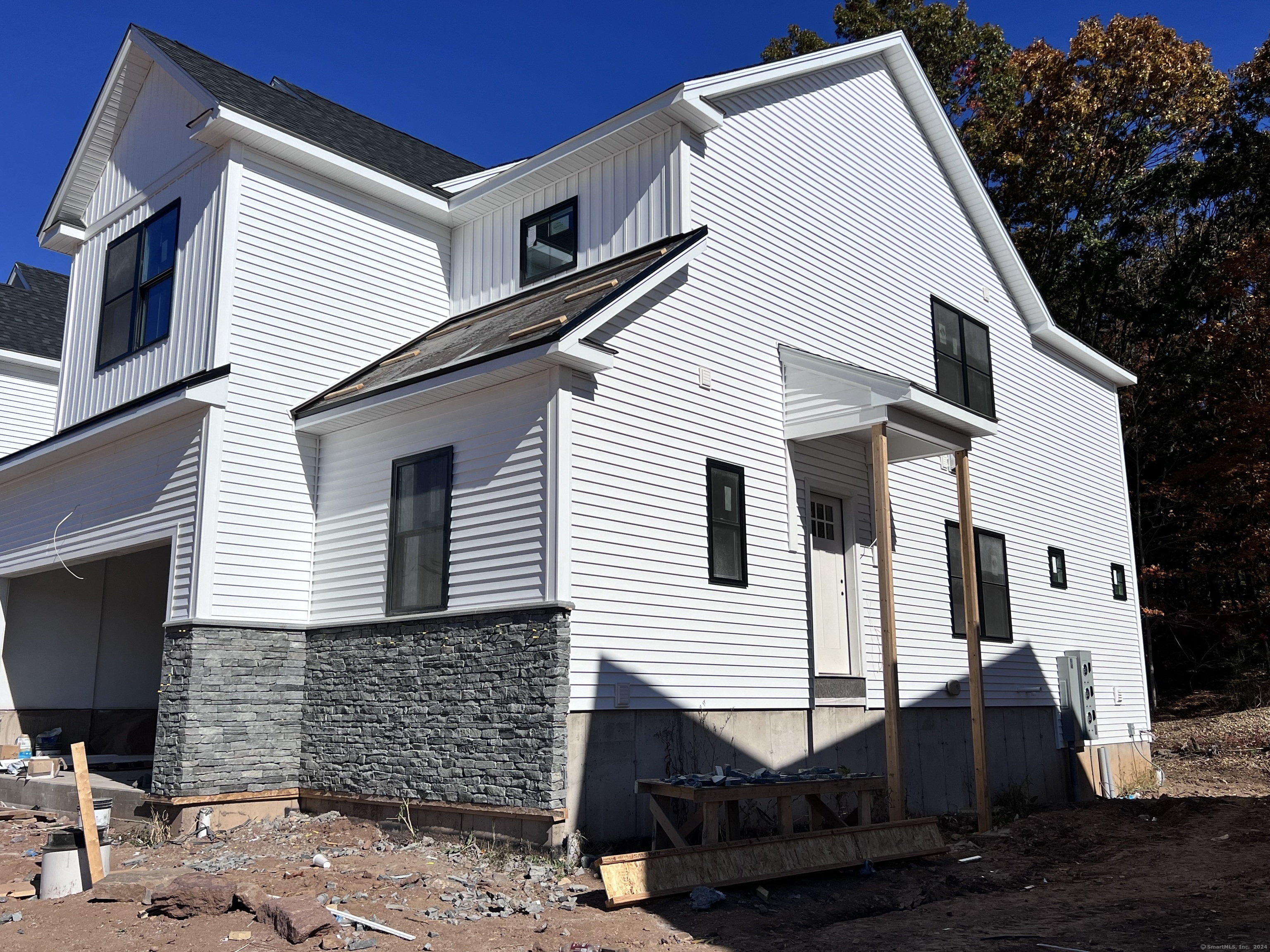 33 Village Circle, Unit 33 Guilford, CT 06437 - Photo 3 of 14 a view of a white house with many windows