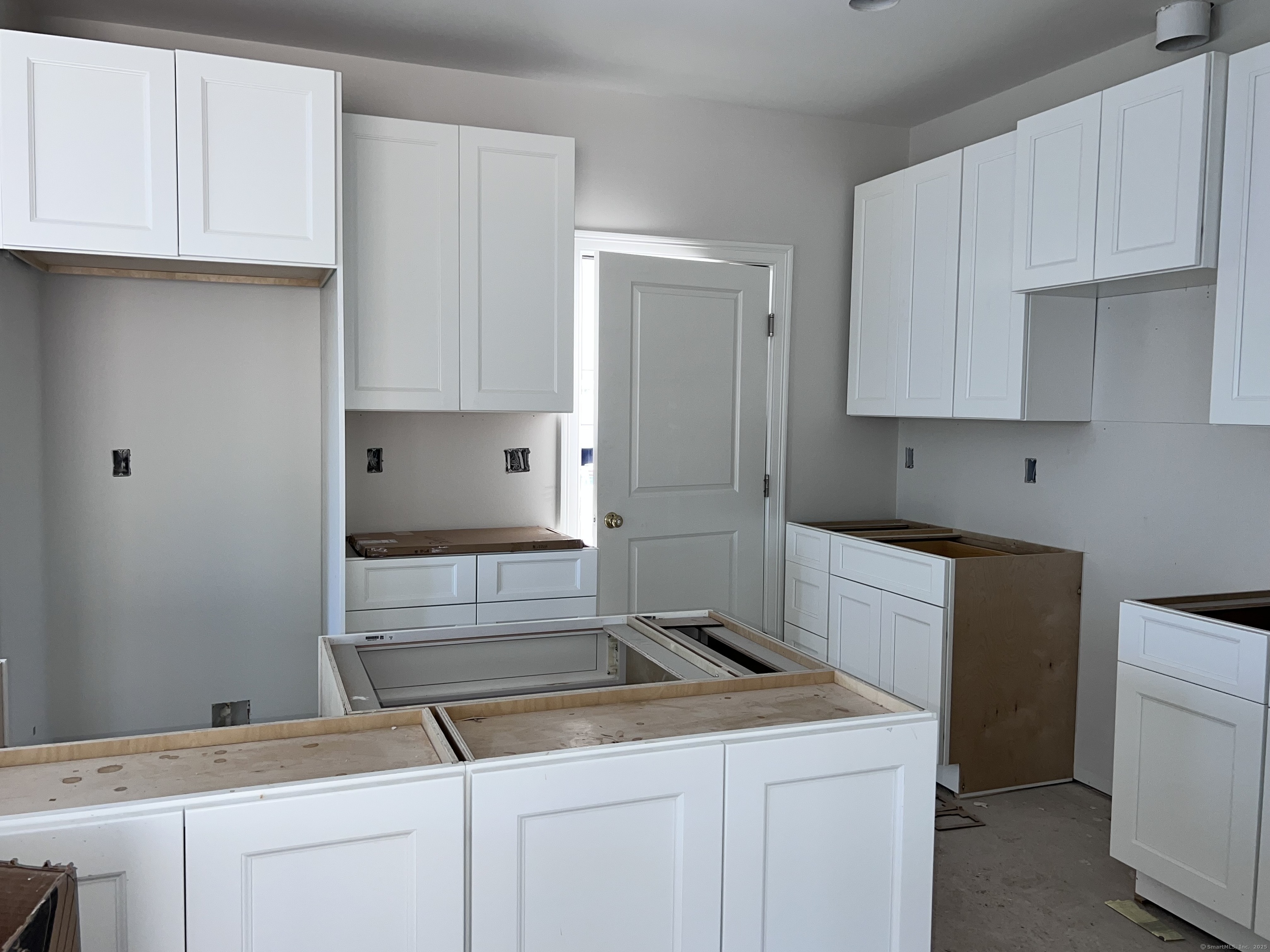 33 Village Circle, Unit 33 Guilford, CT 06437 - Photo 8 of 14 a kitchen with granite countertop white cabinets and white appliances