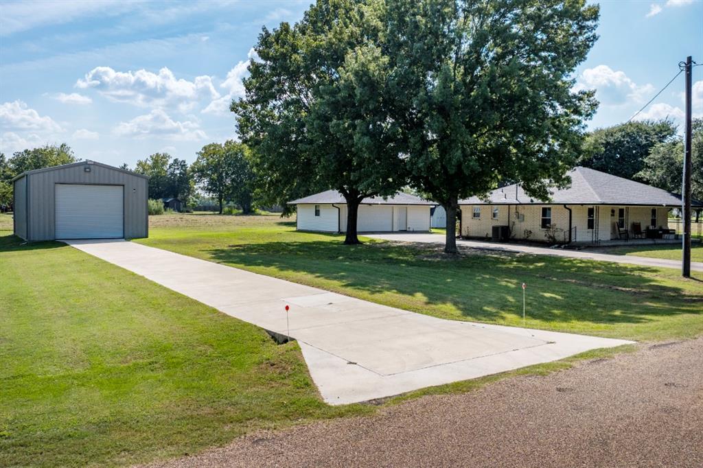 a view of yard with swimming pool and green space