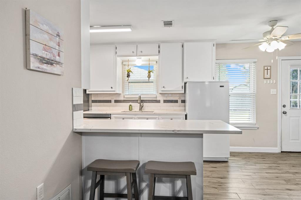 302 Santa Rosa Road, Unit R Trinidad, TX 75163 - Photo 12 of 23 a kitchen with stainless steel appliances granite countertop a sink and a refrigerator