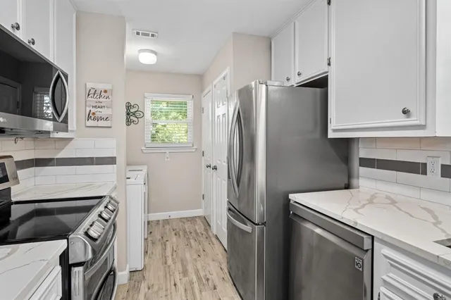 a kitchen with a refrigerator stove and microwave