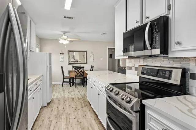 a kitchen with a stove and a microwave