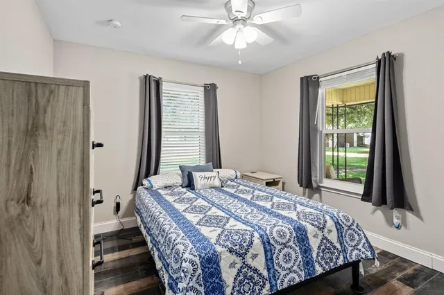 a bedroom with a bed and a flat tv screen