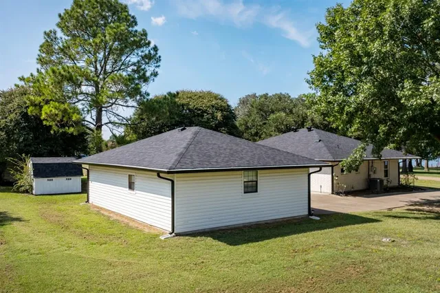 a aerial view of a house with a yard table and chairs