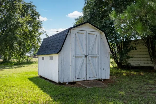 a view of backyard with tub and trees