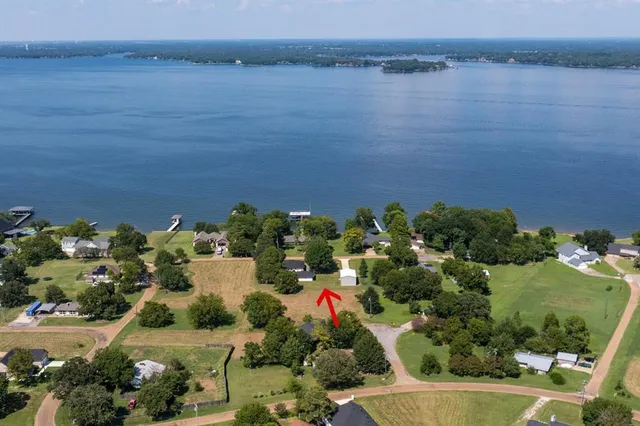 an aerial view of a house with a lake view
