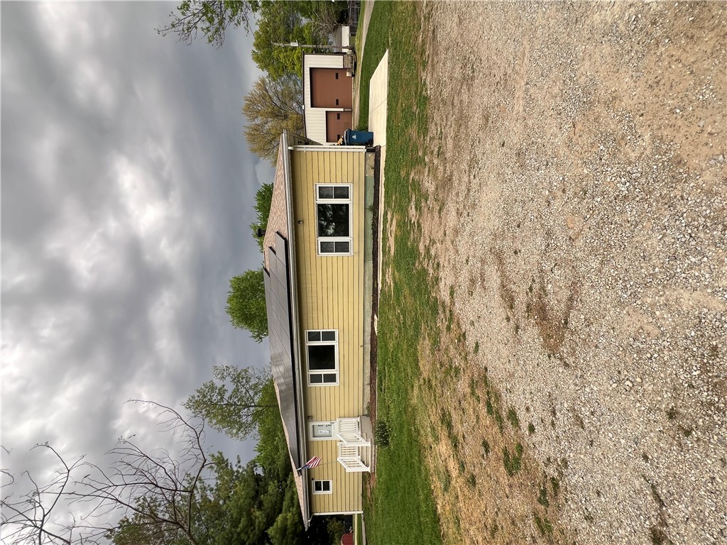 195 Kessler Cowl Road Tipp City, OH 45371 - Photo 1 of 1 This house features a charming porch and solar panels, set on a gravel lot.