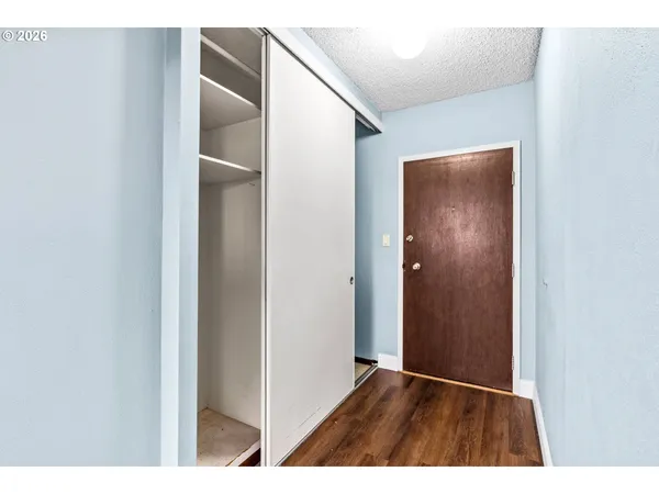 a view of an empty room with wooden floor