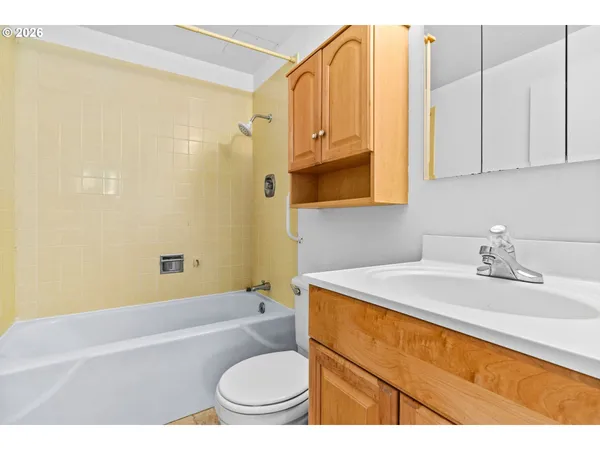 a bathroom with a sink a toilet and bathtub