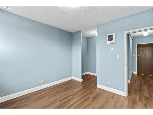 a view of an empty room with wooden floor
