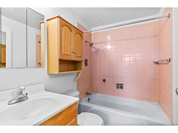 a bathroom with a sink a mirror and a bathtub