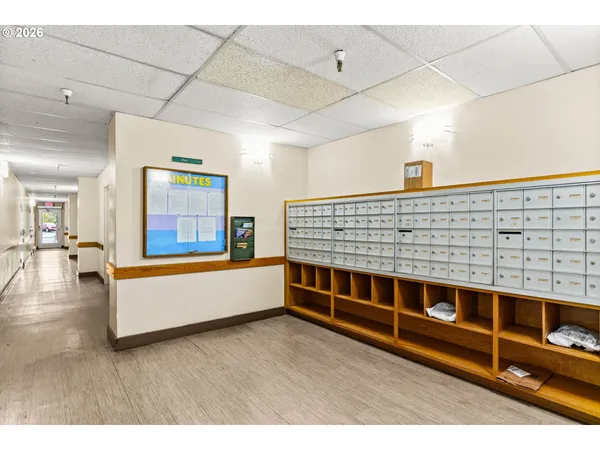 a view of living room with stainless steel appliances wooden floor and potted plant