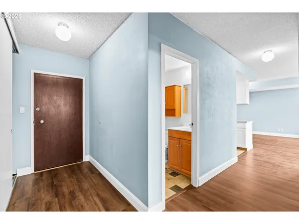 a view of hallway with wooden floor