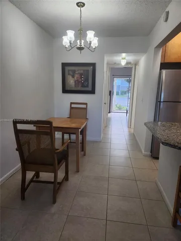a dining room with furniture and chandelier