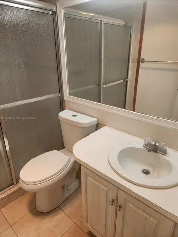 a white toilet sitting next to a bathroom sink