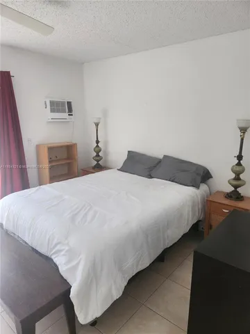 a bedroom with a bed and a lamp with window