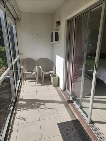 a view of balcony with furniture