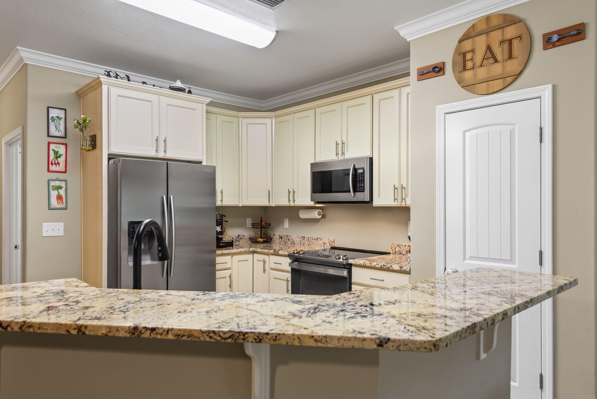 765 Ridge Lake Road Crestview, FL 32536 - Photo 16 of 46 a kitchen with stainless steel appliances granite countertop a refrigerator a stove and a sink