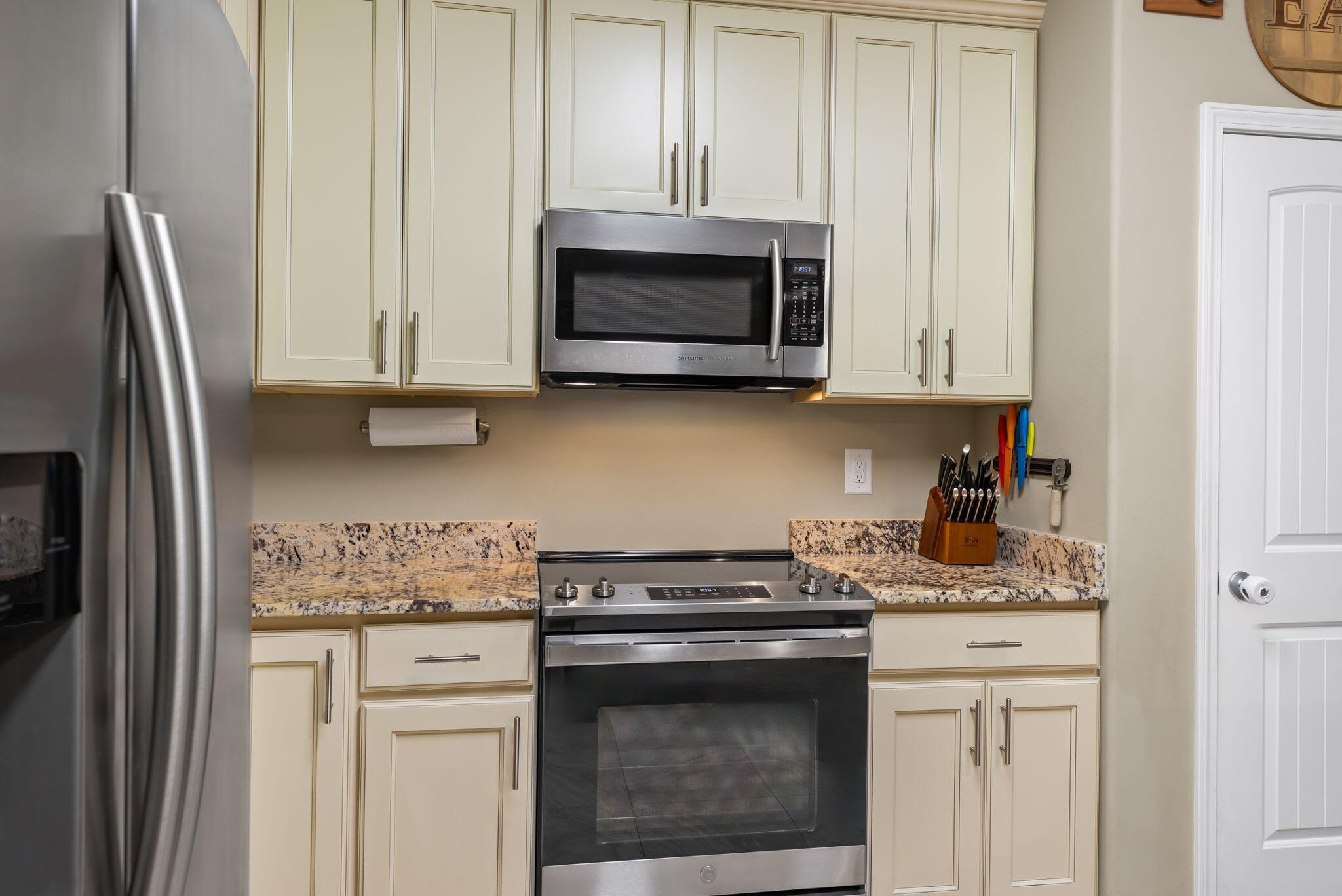 765 Ridge Lake Road Crestview, FL 32536 - Photo 17 of 46 a kitchen with stainless steel appliances granite countertop white cabinets and a stove