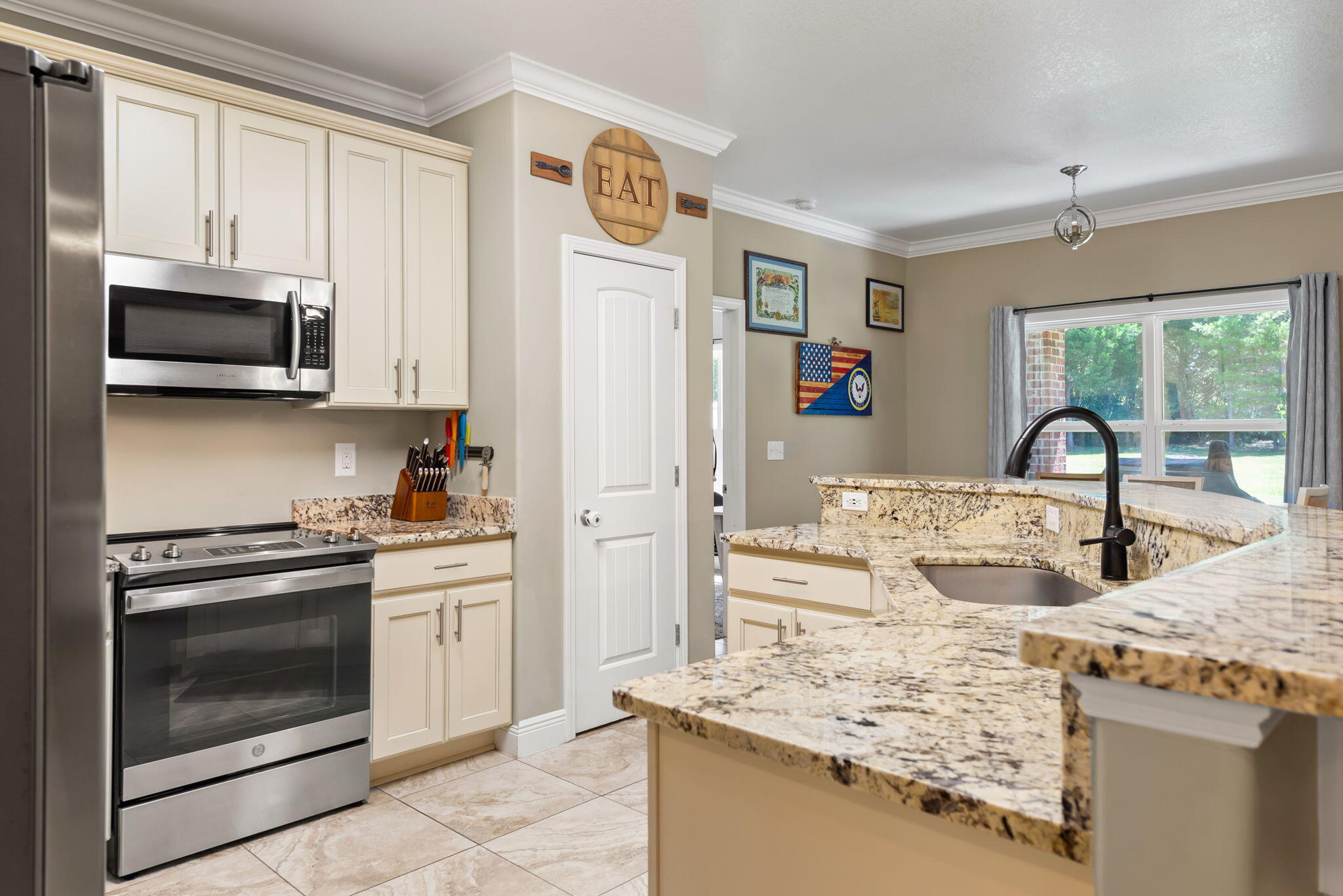 765 Ridge Lake Road Crestview, FL 32536 - Photo 18 of 46 a kitchen with stainless steel appliances granite countertop a stove a sink and a refrigerator