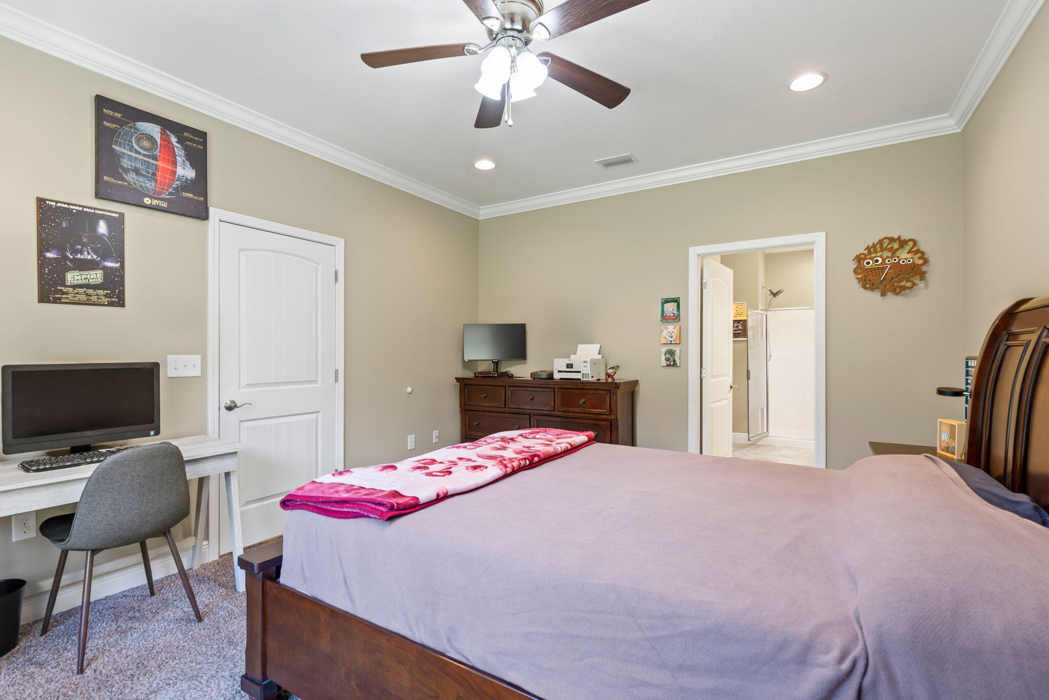765 Ridge Lake Road Crestview, FL 32536 - Photo 22 of 46 a bedroom with a bed a chandelier and a chair