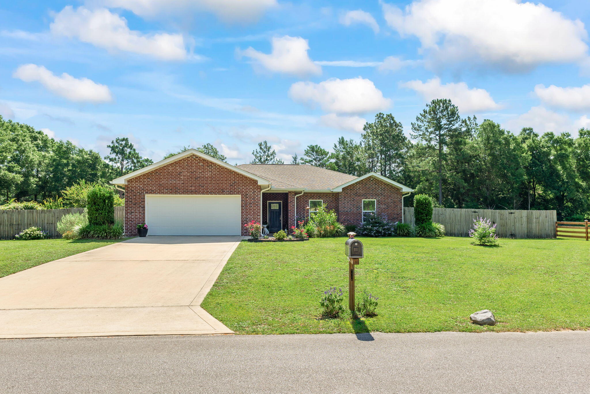 765 Ridge Lake Road Crestview, FL 32536 - Photo 3 of 46 a front view of a house with a yard and garage