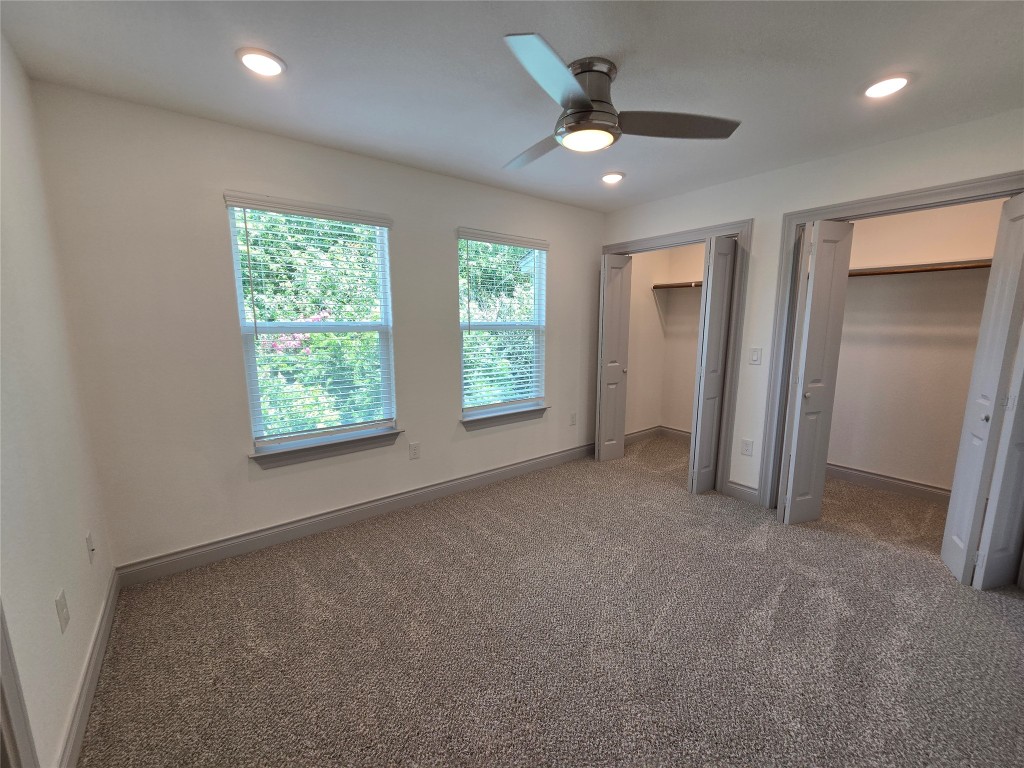 2105 Tiger Trail, Unit 702 Round Rock, TX 78664 - Photo 15 of 22 an empty room with windows and ceiling fan