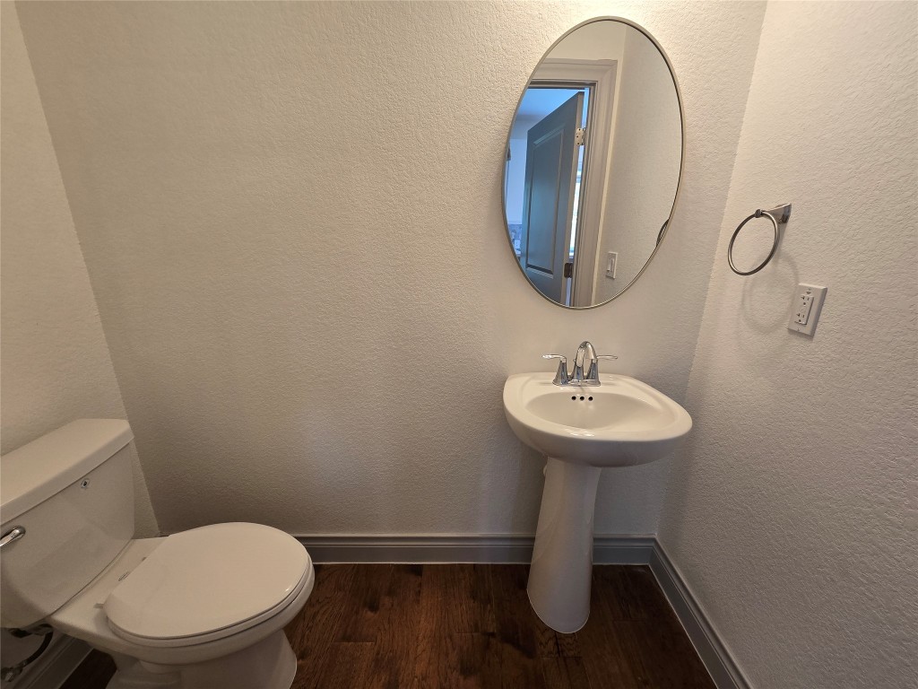 2105 Tiger Trail, Unit 702 Round Rock, TX 78664 - Photo 6 of 22 a bathroom with a toilet sink and mirror