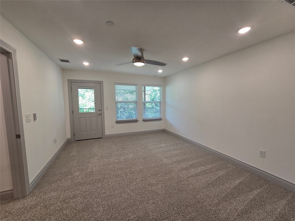 2105 Tiger Trail, Unit 702 Round Rock, TX 78664 - Photo 7 of 22 an empty room with windows and ceiling fan
