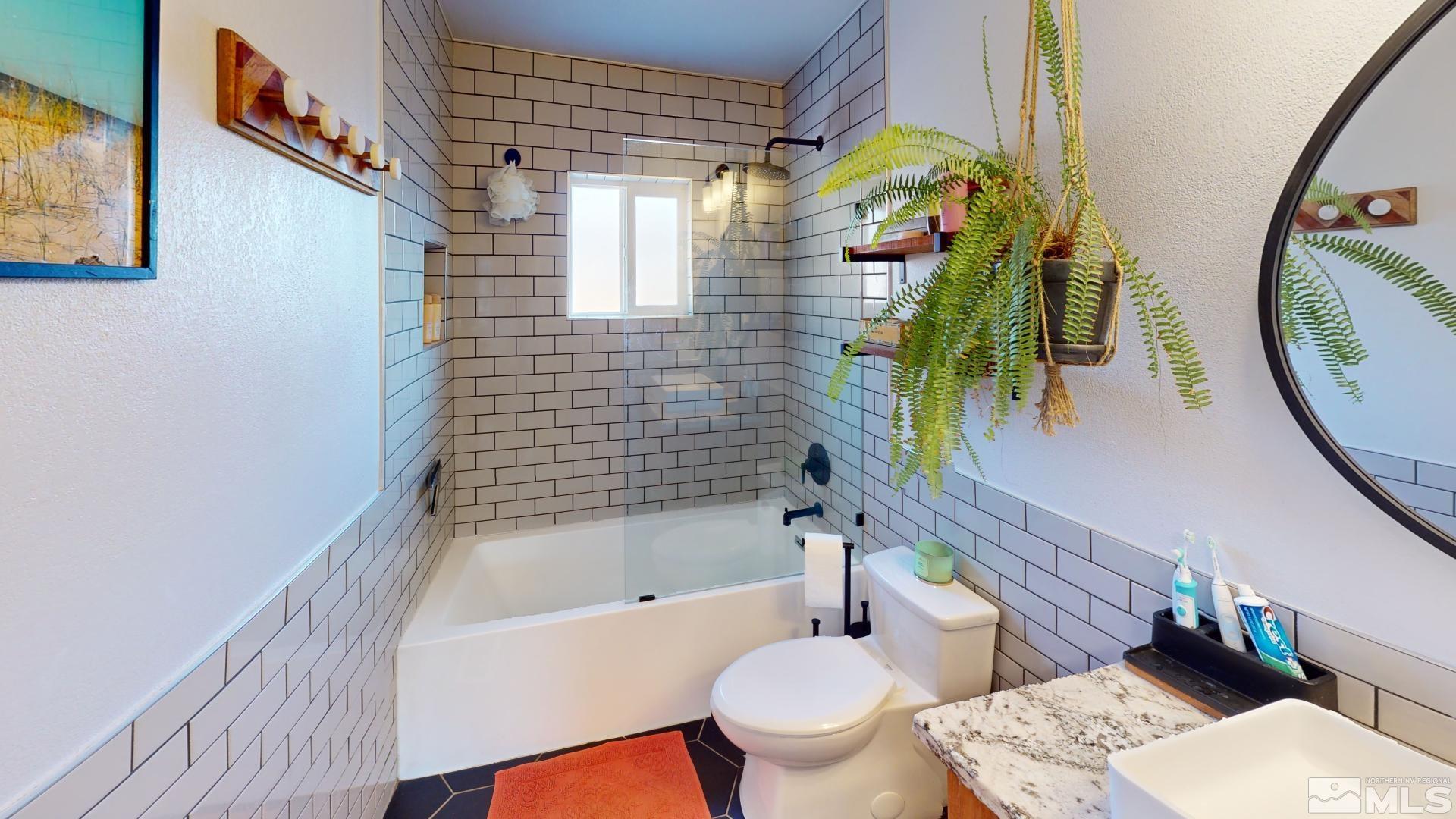 945 Cordone Avenue Reno, NV 89502 - Photo 15 of 33 a bathroom with a sink a toilet and bathtub