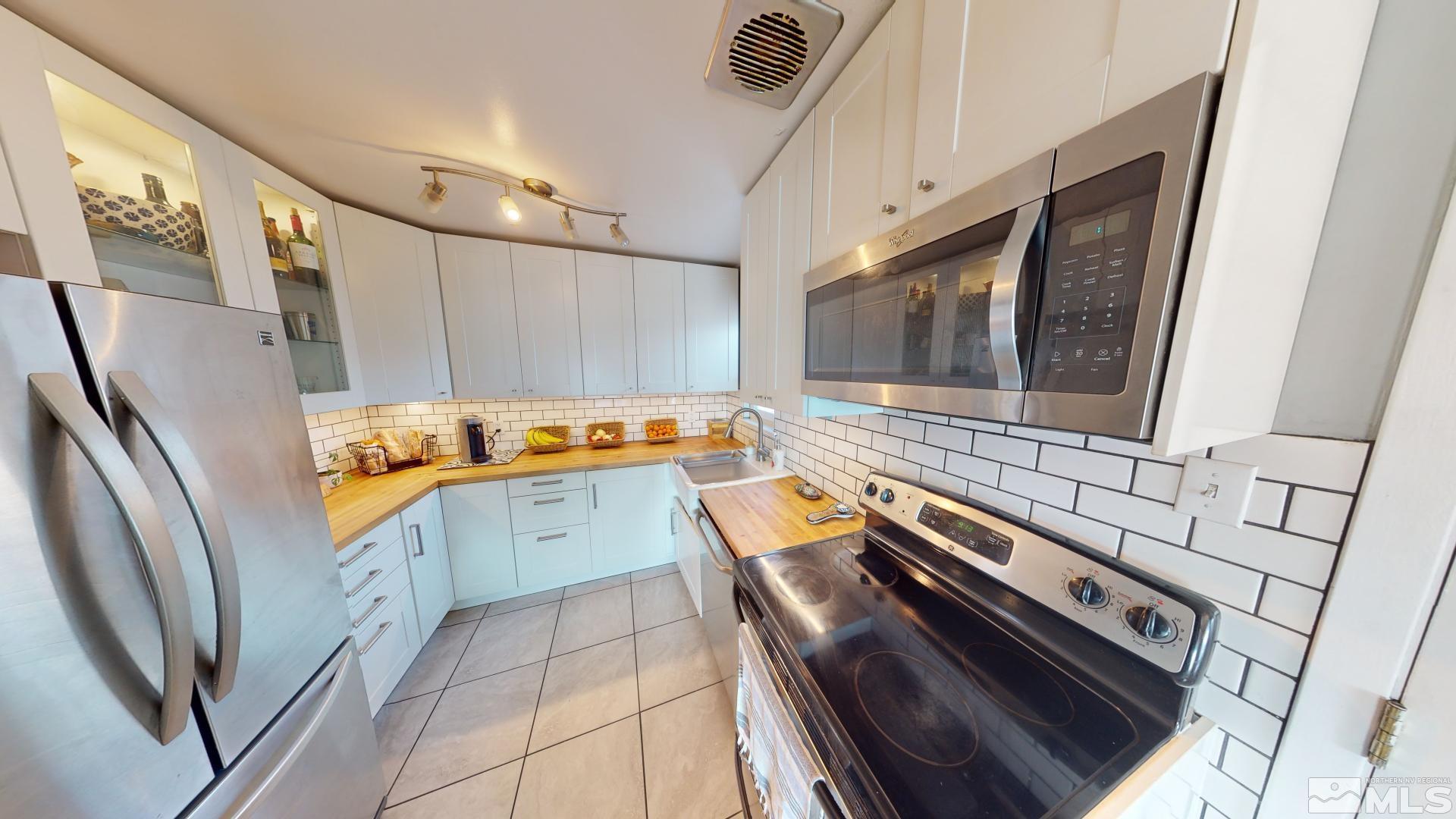 945 Cordone Avenue Reno, NV 89502 - Photo 27 of 33 a kitchen with stainless steel appliances granite countertop a refrigerator and a stove