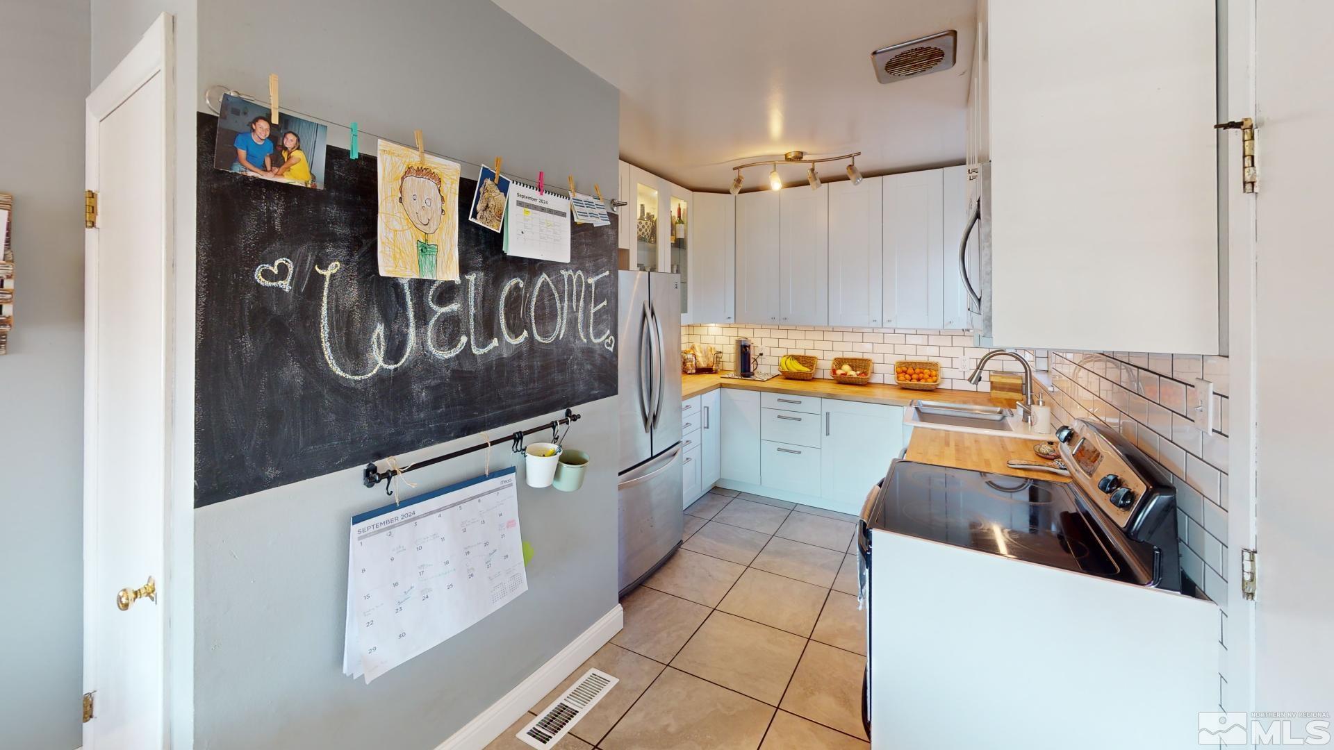 945 Cordone Avenue Reno, NV 89502 - Photo 4 of 33 a kitchen with stainless steel appliances granite countertop a refrigerator and a stove