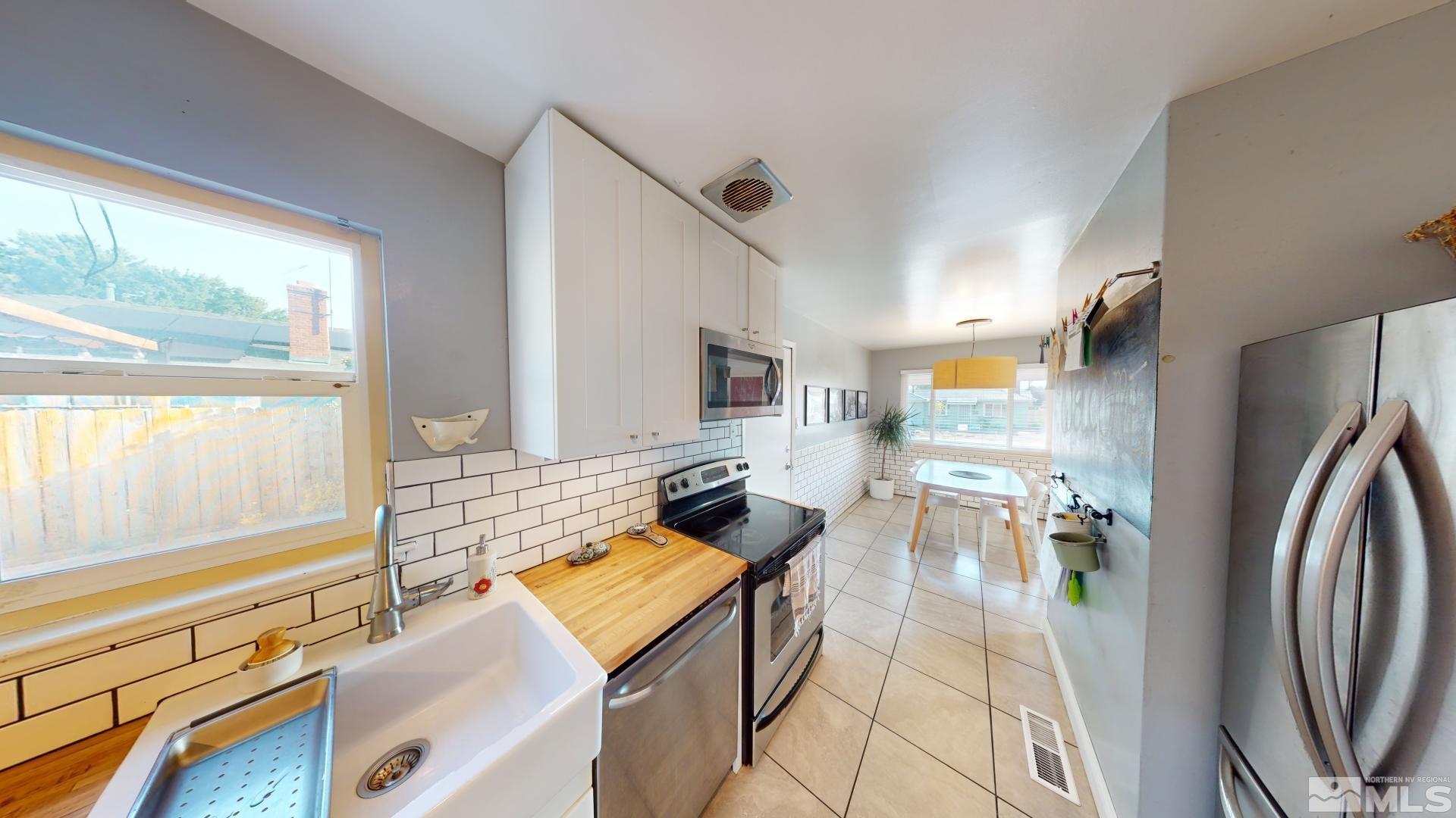 945 Cordone Avenue Reno, NV 89502 - Photo 5 of 33 a living room with furniture stove and a large window