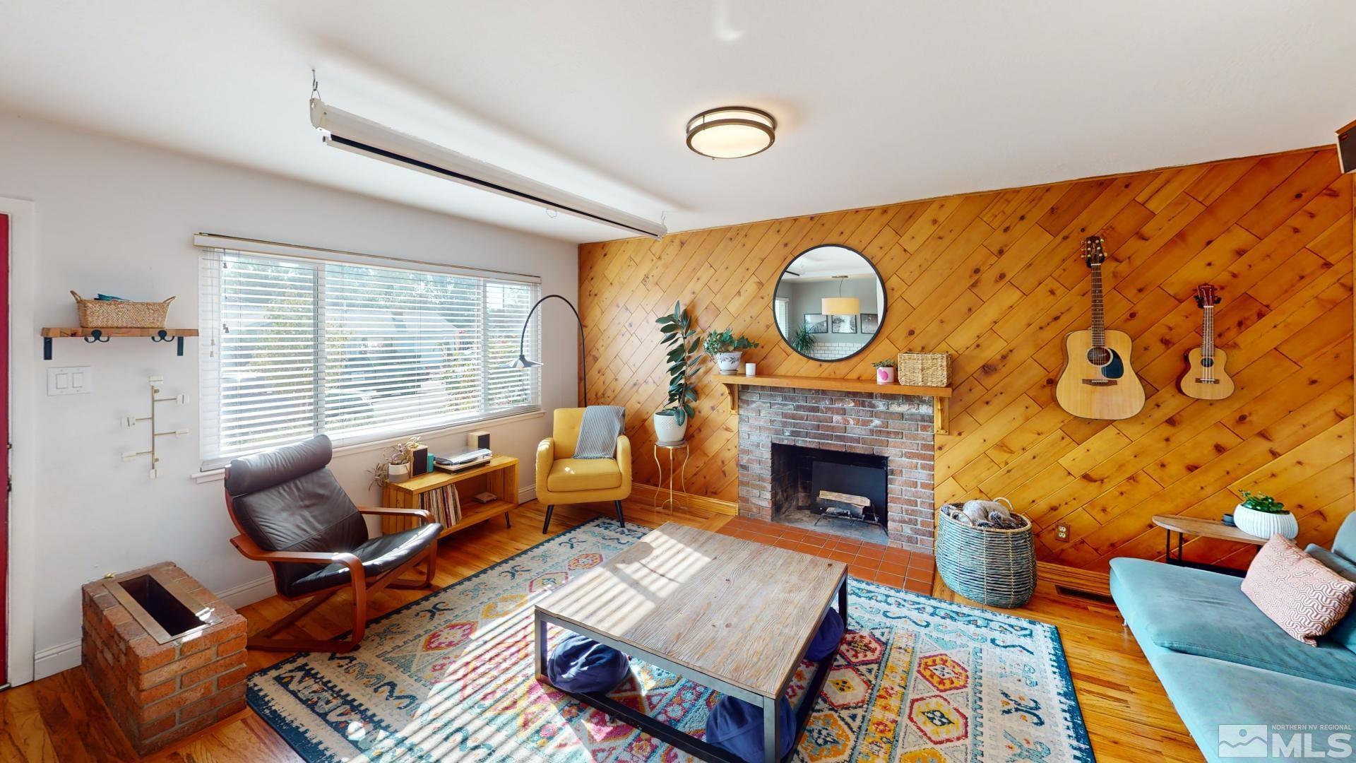 945 Cordone Avenue Reno, NV 89502 - Photo 8 of 33 a living room with furniture a fireplace and a large window
